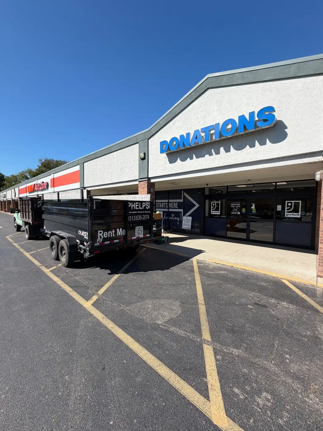 Phelps truck and dump trailer dropping off usable items at a donation center